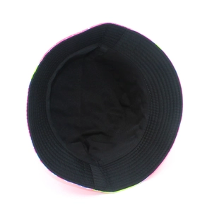 Detail view of double-sided bucket hat showing colorful print and black fabric lining