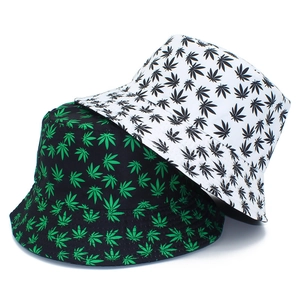 Detail of printed bucket hats featuring vibrant maple leaf patterns and cotton twill fabric