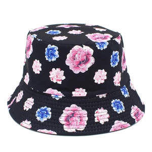 Close-up of pink and blue floral print on black canvas sun hat showing detail