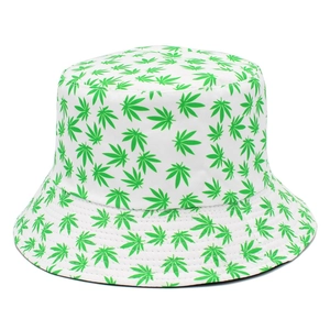 Detailed macro view of green marijuana leaf print on white canvas bucket hat fabric