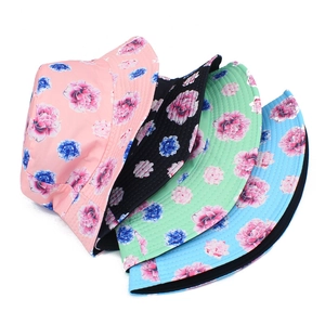 Close-up of floral bucket hats in pink black green and blue showing vibrant peony patterns