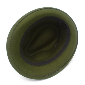 Detailed interior view of a green fedora hat featuring the black cotton blend lining tag