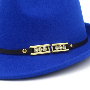 Detail of royal blue wool felt fedora with black ribbon and rhinestone gold buckles