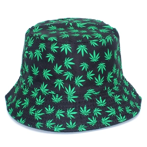 Close-up of black bucket hat featuring vivid green maple leaf patterns and durable fabric