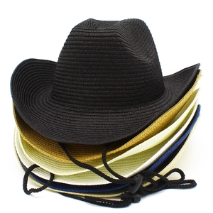 Detail showing various colors of woven straw cowboy hats with adjustable chin straps