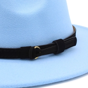 Detail of light blue wool felt fedora with black velvet band and gold metal buckle