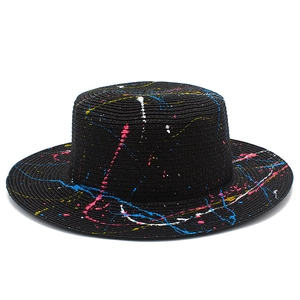 Artistic black boater straw hat with vibrant colorful paint splatter for beach sun protection