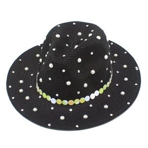 Detail of black straw fedora featuring white pearls, rhinestones and sequin band