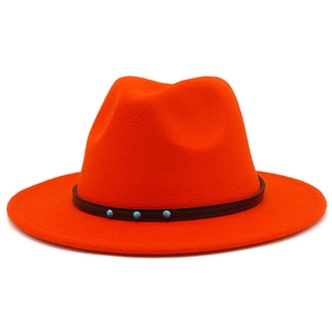 Detail of orange fedora hat featuring a brown textured leather band with turquoise studs