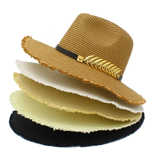 Stacked woven straw jazz hats with fringe brims and gold leaf charms in multiple colors