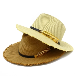 Straw beach jazz hat with fishbone metal accessory and frayed edges in beige and brown