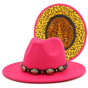 Detail of rose red fedora hat with leopard print brim and metallic sun rivets