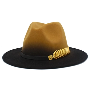Detail of the brown to black gradient wool fedora hat with a golden feather pin