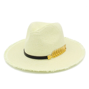 Classic cream woven sun hat with frayed brim and golden leaf accent for outdoor wear