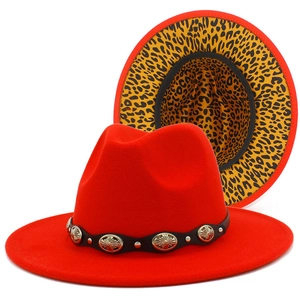 Detail view of red fedora hat with metal buckle leather band and leopard print brim underside
