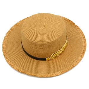 Detail of flat top straw boater hat with black ribbon, gold leaf pin and frayed edges