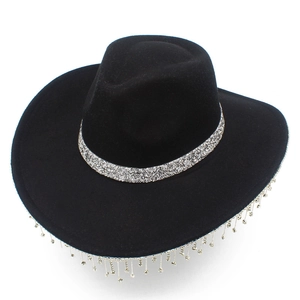 Detail shot of black felt cowboy hat featuring sparkly rhinestone fringe and silver sequin band