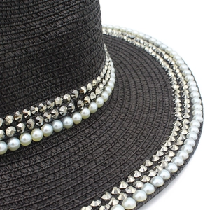 Summer black Panama straw sun hat with elegant pearl and silver rivet trim on the wide brim