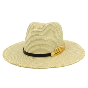 Macro detail of the straw fedora featuring a gold leaf accent and raw fringe edge