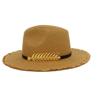 Detail of khaki straw fedora with black leather band and golden leaf ornament