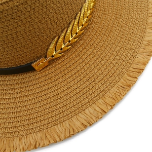 Straw sun hat with leaf accessory and frayed edges for summer seaside vacation