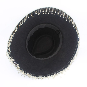 Detailed view of black cowboy hat interior showing the fabric care label and brim