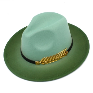 Detail of mint green gradient wool felt hat featuring a black band with golden wheat buckle