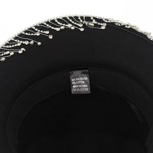 Detail of western cowboy hat showing rhinestone tassel fringe and fabric composition label