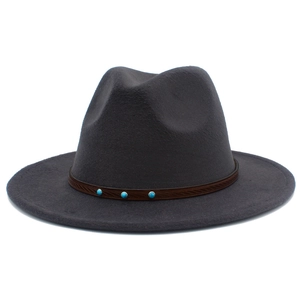 Detail of dark grey wool felt fedora hat featuring brown leather band with turquoise studs