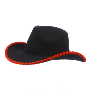Detailed side view of black felt cowboy hat with distinctive red woven trim on the brim