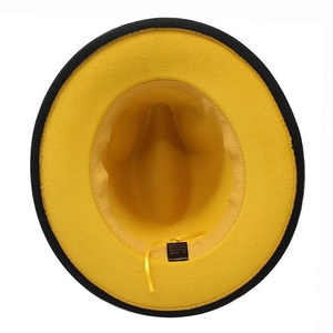 Detail view of yellow felt hat interior showing 65% cotton blend fabric and adjustable strap