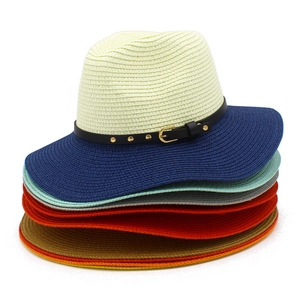 Close-up of stacked straw hats with rivet leather bands and various color brim options