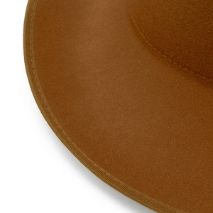 Close-up of the meticulous stitching and ribbed edge detail on a brown wool felt fedora