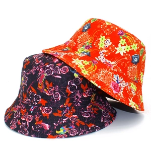 Detail shot of reversible floral bucket hats in red and black with rose and lily prints