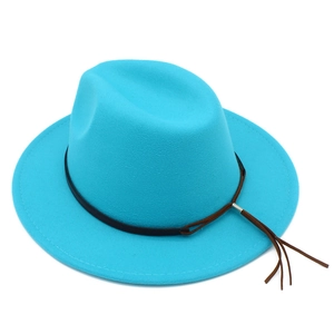 Detail of teal wool fedora hat with a dark brown leather band and tassel accent