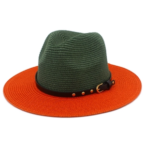 Detailed weave texture of two-tone straw sun hat with rivet band and gold buckle