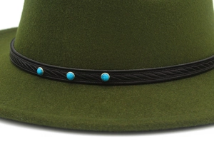 Detail of dark green fedora with black leather braided band and turquoise studs