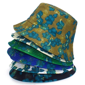 Collection of reversible floral sun hats in various colors with hibiscus prints