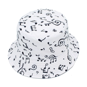 Unisex reversible bucket hat with all-over black music notes print for outdoor sun protection
