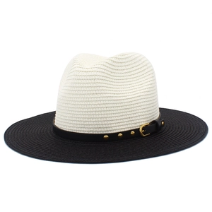 Top-down view of two-tone straw fedora with gold rivet leather band detail