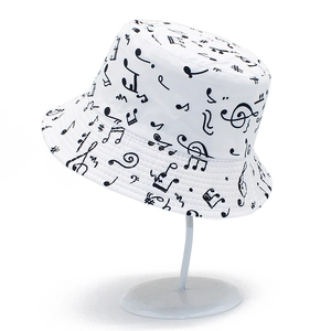 White reversible bucket hat with black musical note patterns for outdoor sun protection