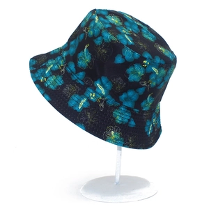 Detail of double-sided bucket hat with blue and yellow tropical floral prints