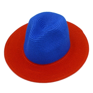 Top view of bicolor woven straw Panama hat with navy crown and red wide brim detailing