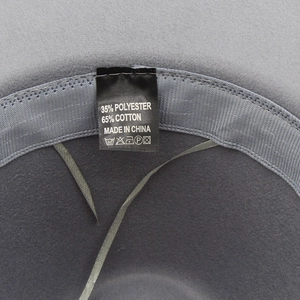 Detailed interior view of wide brim fedora showing fabric care label and sweatband