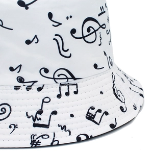White reversible bucket hat with black music note patterns and premium stitching detail