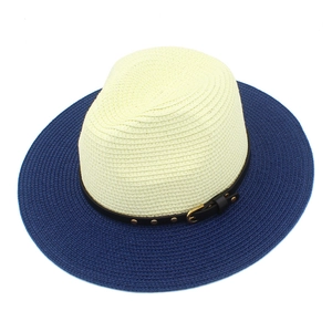 Detail of two-tone straw fedora showing fine weave texture and studded leather band