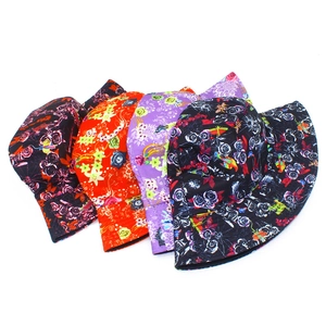 Detail showing four assorted floral and parrot print cotton reversible bucket hats