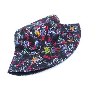 Detailed view of black reversible bucket hat with colorful floral and dragonfly prints