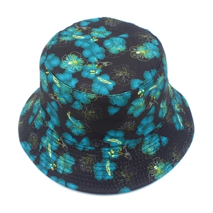 Detail view of tropical hibiscus floral print on a black reversible bucket hat fabric