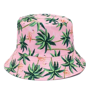 Detail shot of pink bucket hat with tropical palm tree and flamingo patterns on canvas